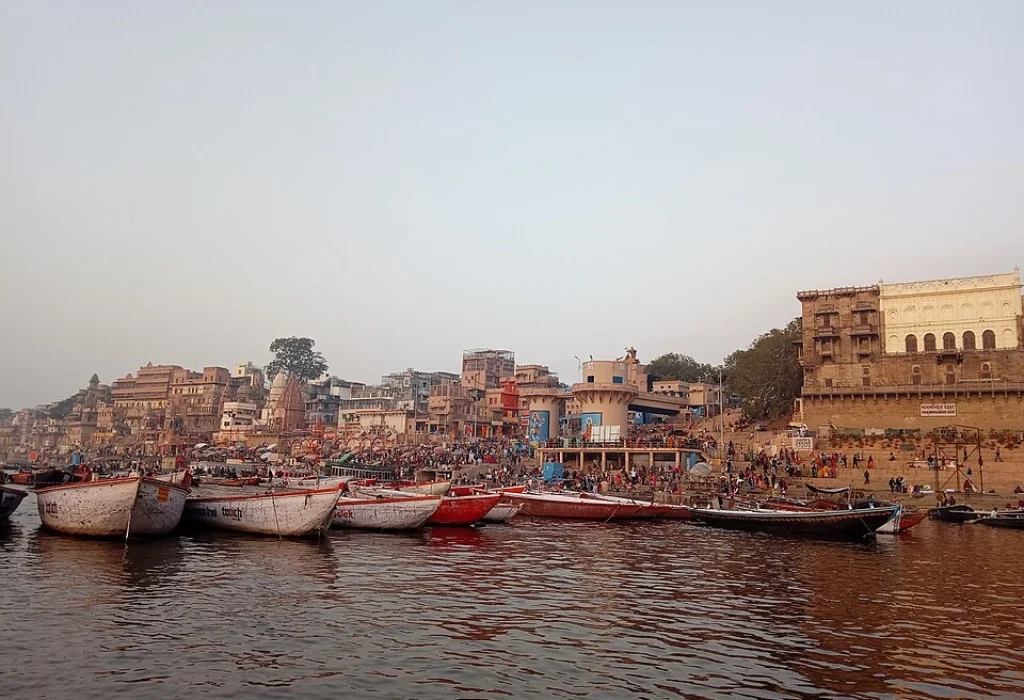 Dashashwamedh Ghat in Varanasi showing boats, riverfront steps, temples, and daily life by the Ganga.