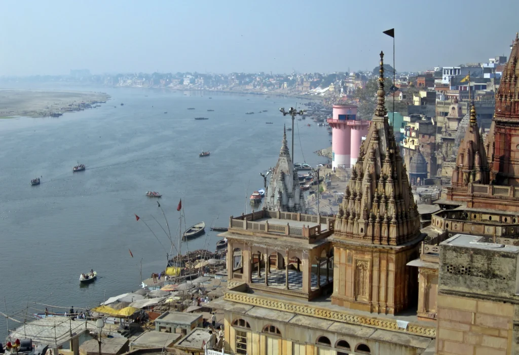 Wide view of Varanasi ghats across the Ganges River showing the historic riverfront.