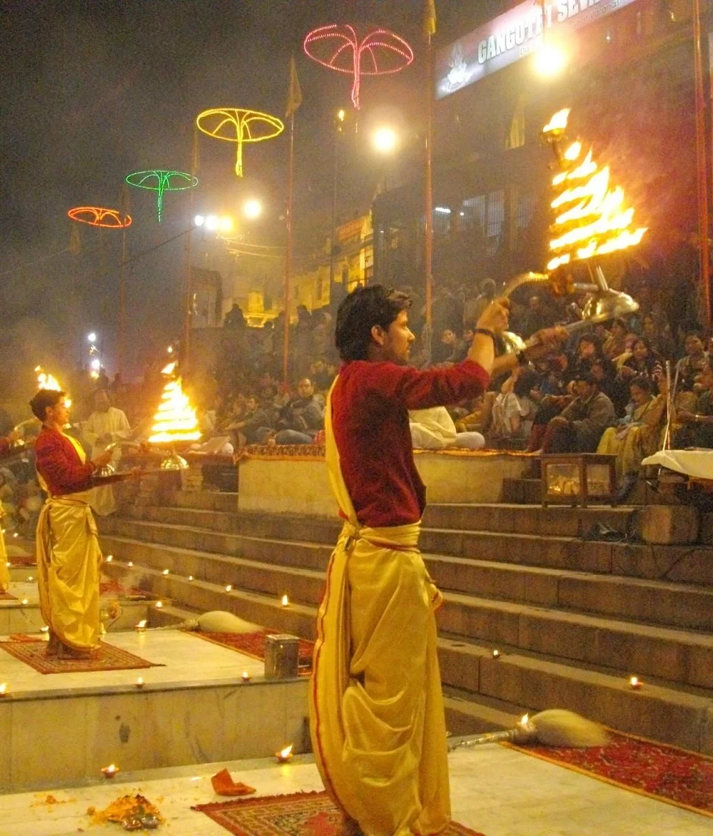 Evening Ganga Aarti ceremony at Dashashwamedh Ghat in Varanasi with priests and lamps.