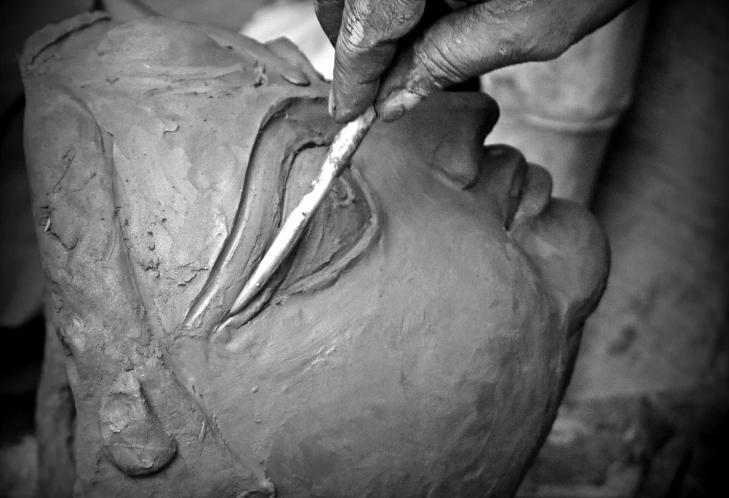 Artisan sculpting a Durga idol in Kumartuli Kolkata before Durga Puja.